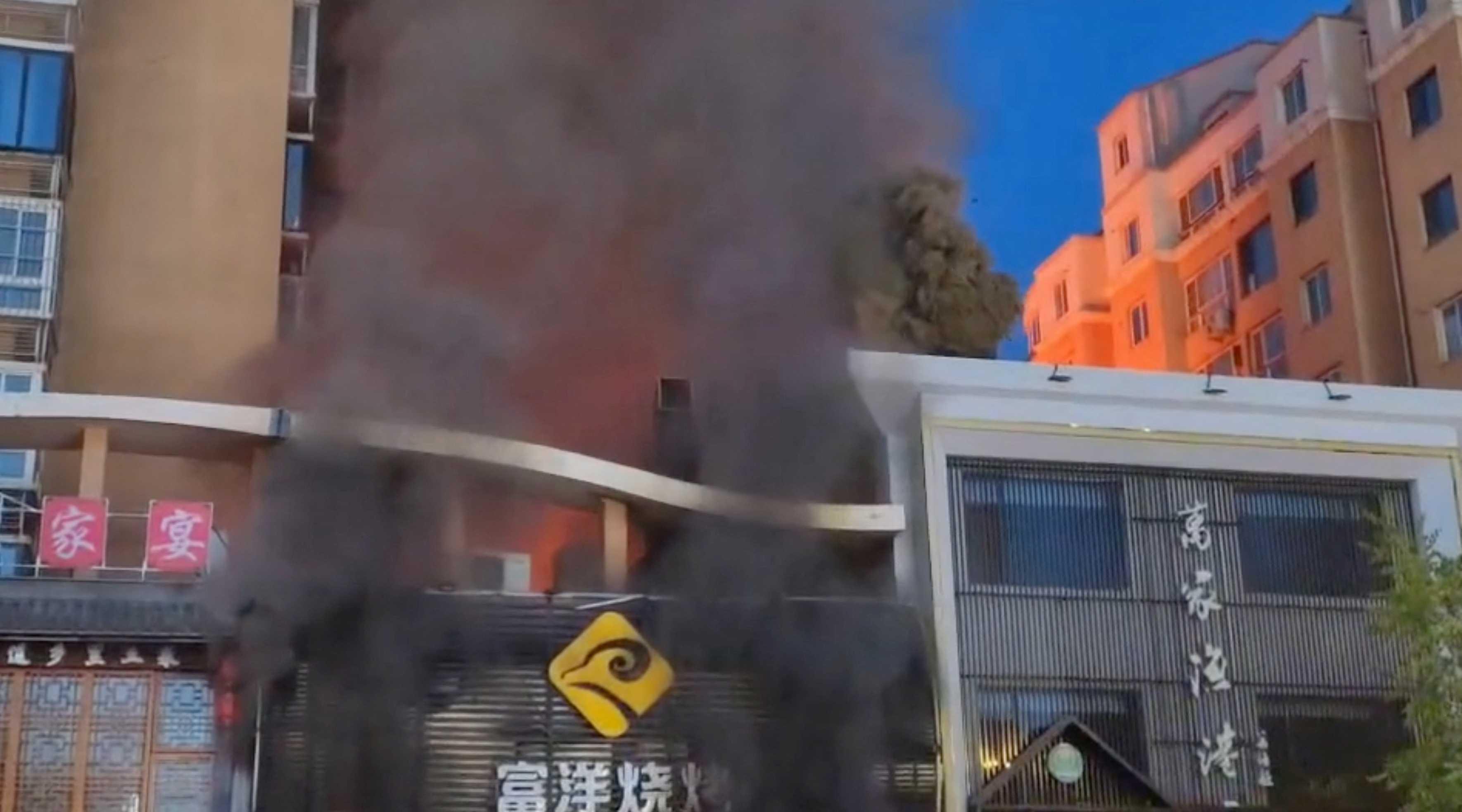 Smoke rises from a building following a gas explosion at a barbecue restaurant in Yinchuan city, Ningxia, China, June 21, in this screengrab obtained from a handout video. Photo: Reuters