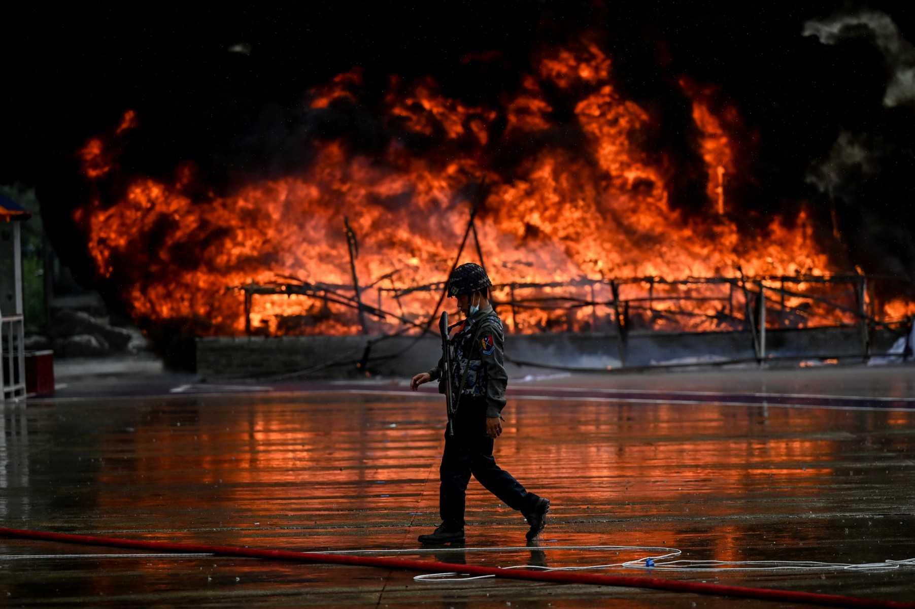 A policeman walks past a burning pile of seized illegal drugs during a destruction ceremony to mark the United Nations' 'International Day against Drug Abuse and Illicit Trafficking' in Yangon on June 26, 2022. Photo: AFP