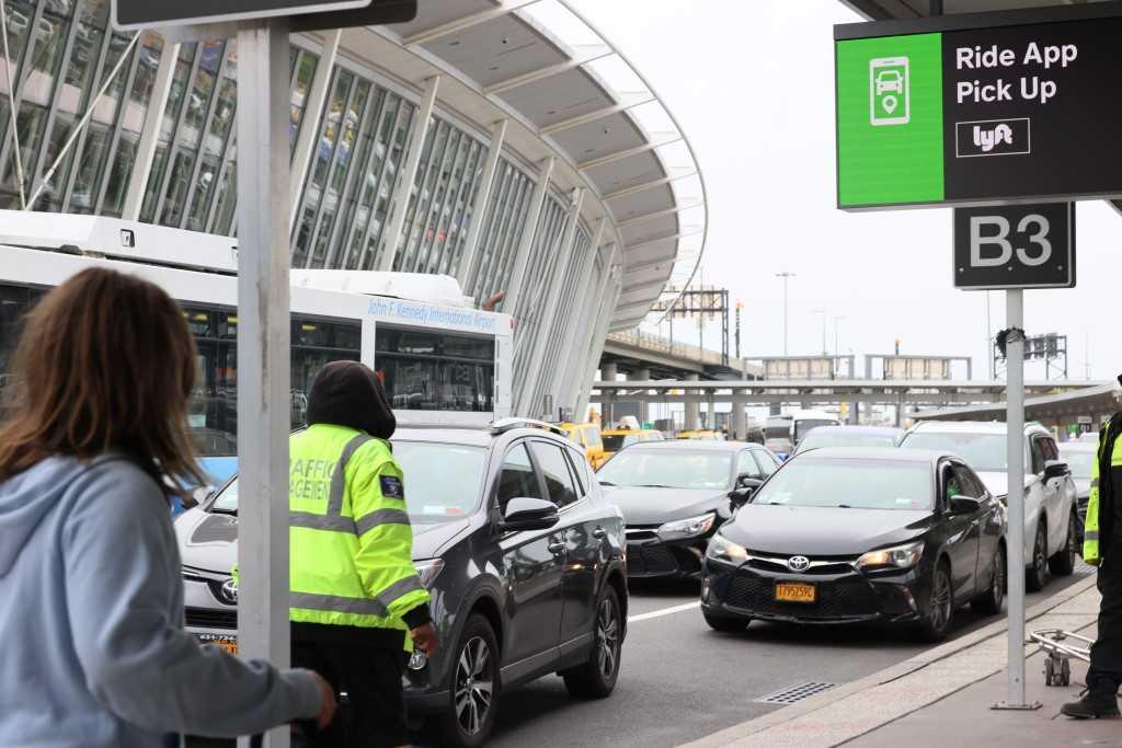 People wait for cars in the pick-up area at JFK Airport on April 28, in New York City. Photo: AFP