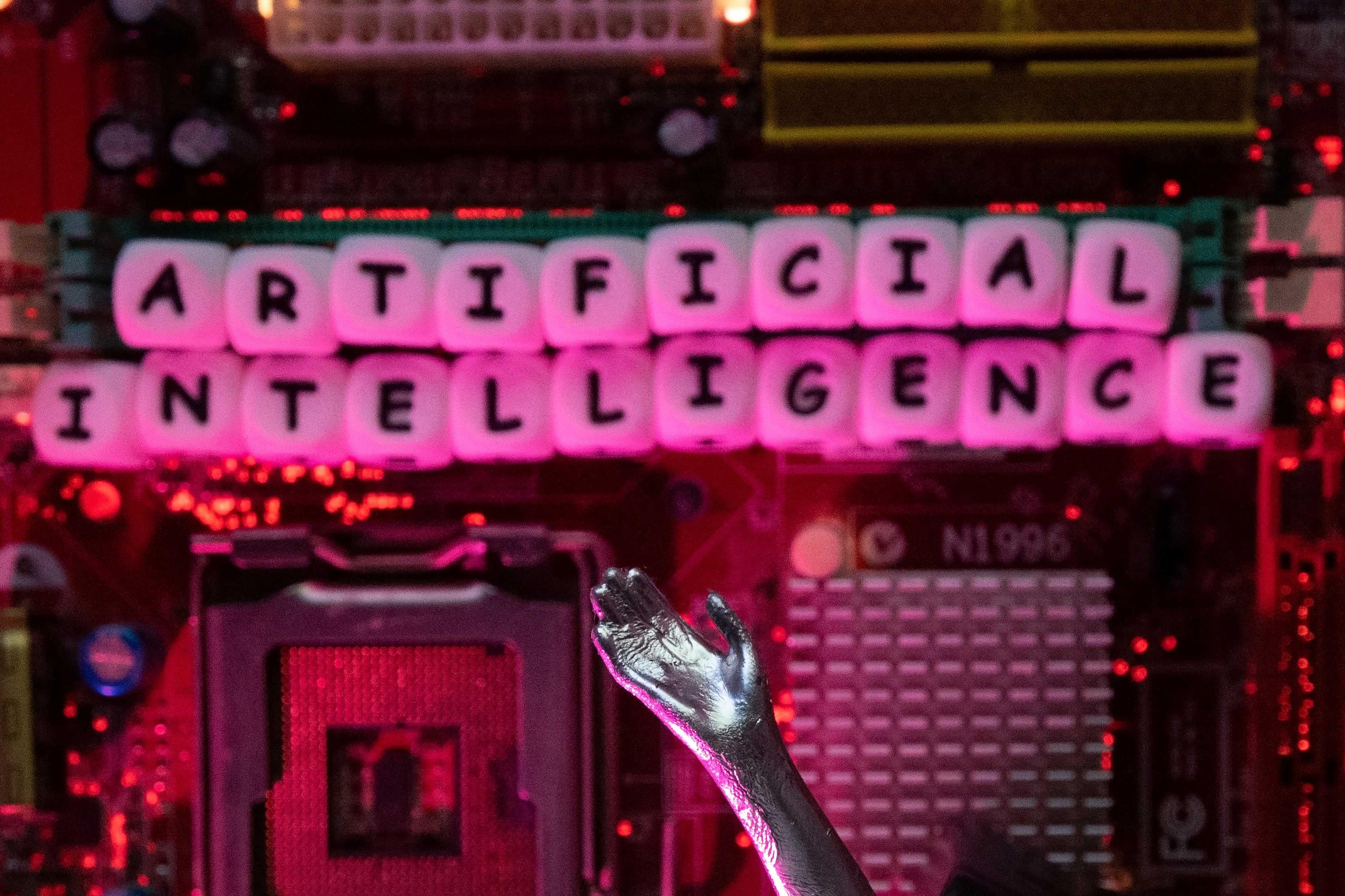 AI letters and a robot hand are placed on a computer motherboard in this illustration taken, June 23. Photo: Reuters