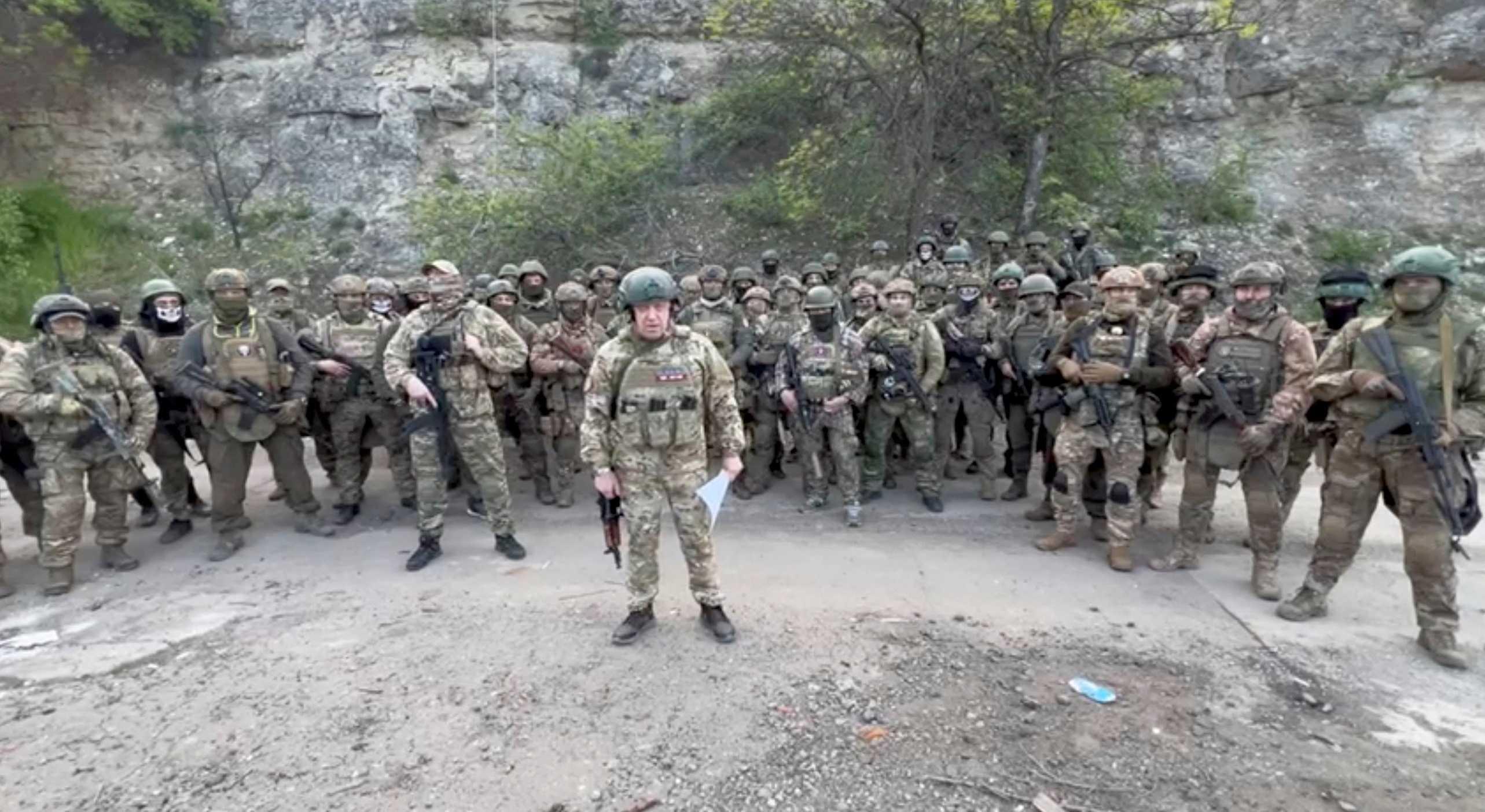 Founder of Wagner private mercenary group Yevgeny Prigozhin makes a statement as he stand next to Wagner fighters in an undisclosed location in the course of Russia-Ukraine conflict, in this still image taken from video released May 5. Photo: Reuters