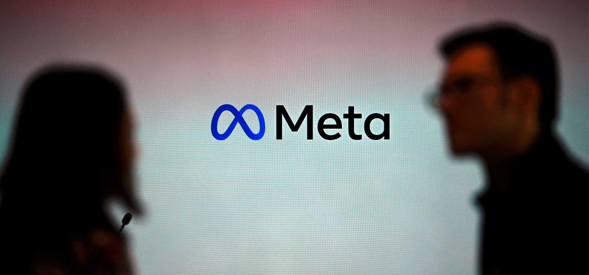 Visitors stand in front of a Meta logo during a launch event at the corporate offices of Meta in Berlin on June 6. Photo: AFP