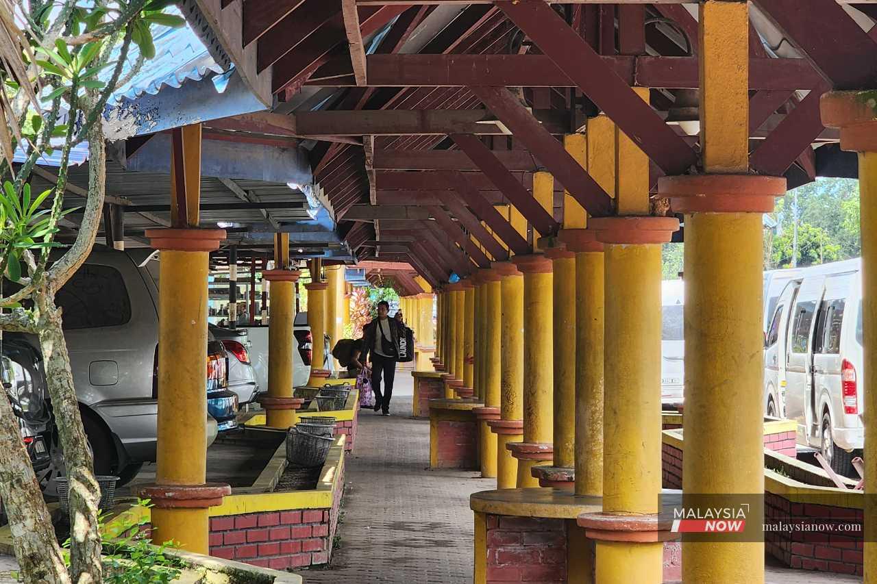 A traveller heads towards the Immigration, Customs, Quarantine and Security Complex in Rantau Panjang, Kelantan.