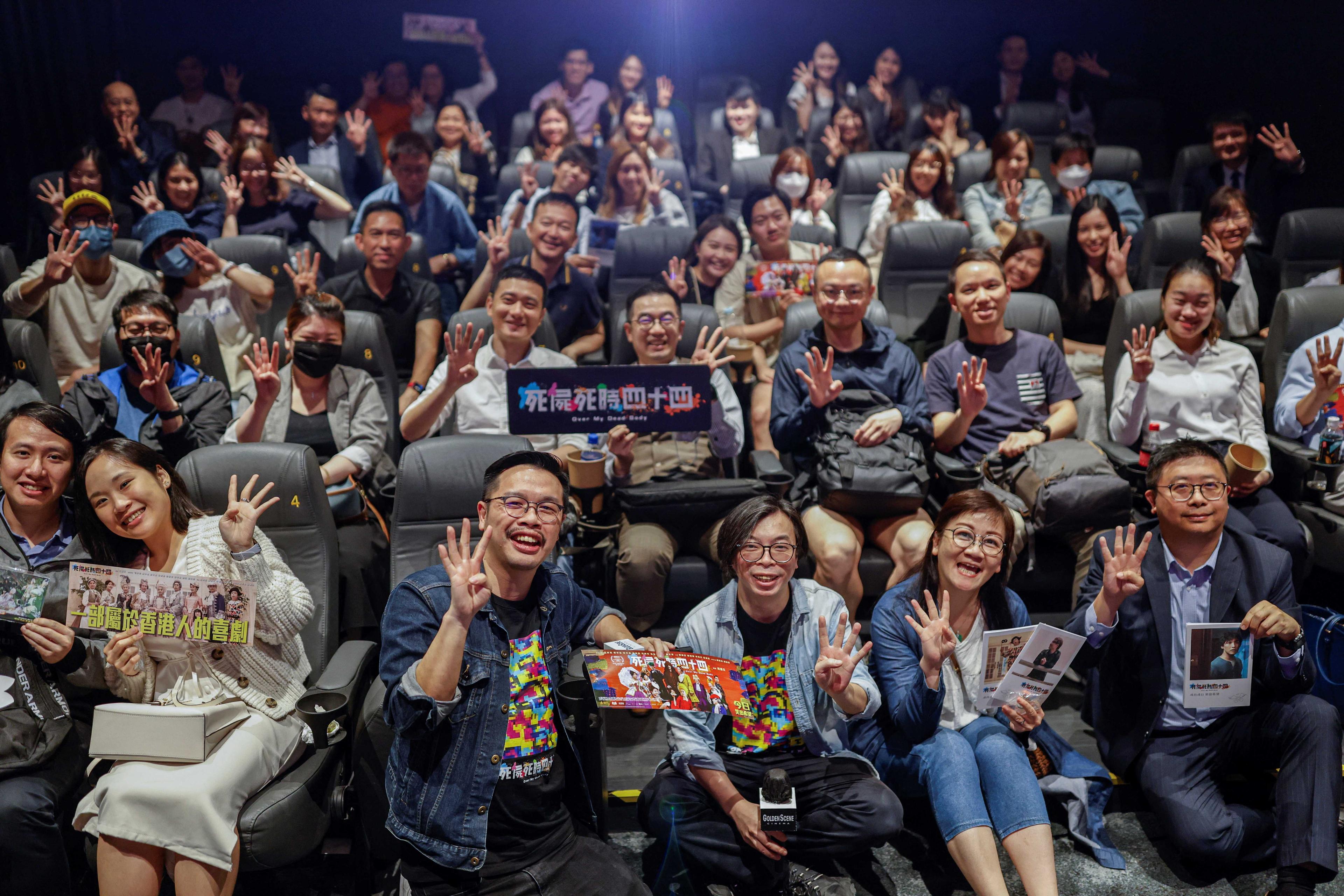 Director Ho Cheuk-Tin and actor Yeung Wai Lun pose with audience after a private screening of Ho's movie 'Over My Dead Body' in Hong Kong, China, May 2. Photo: Reuters