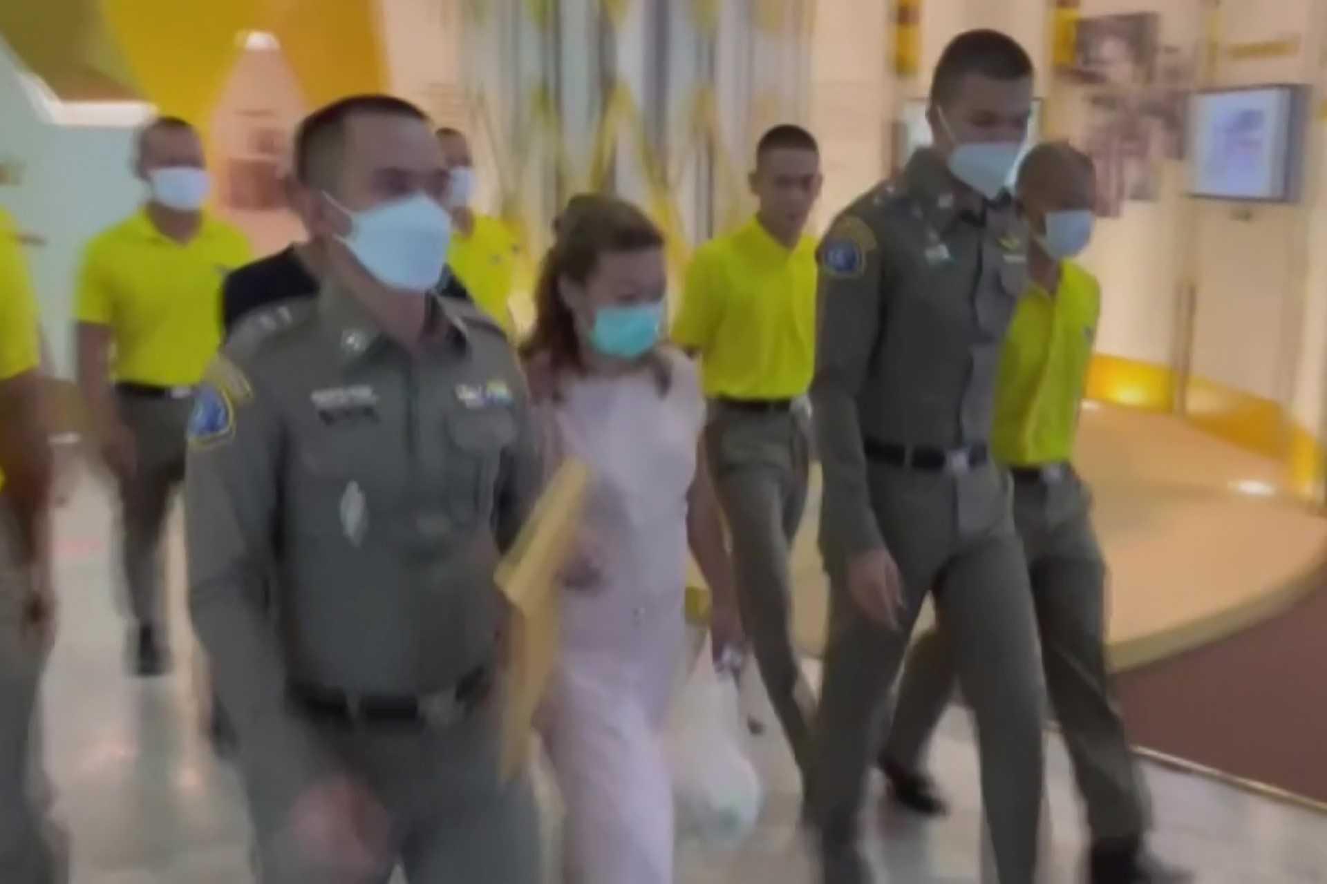 This screen grab taken on April 28, from handout video footage from Thai PBS via AFPTV shows police escorting suspect Sararat Rangsiwuthaporn from a police station in Bangkok on April 26. Photo: AFP 