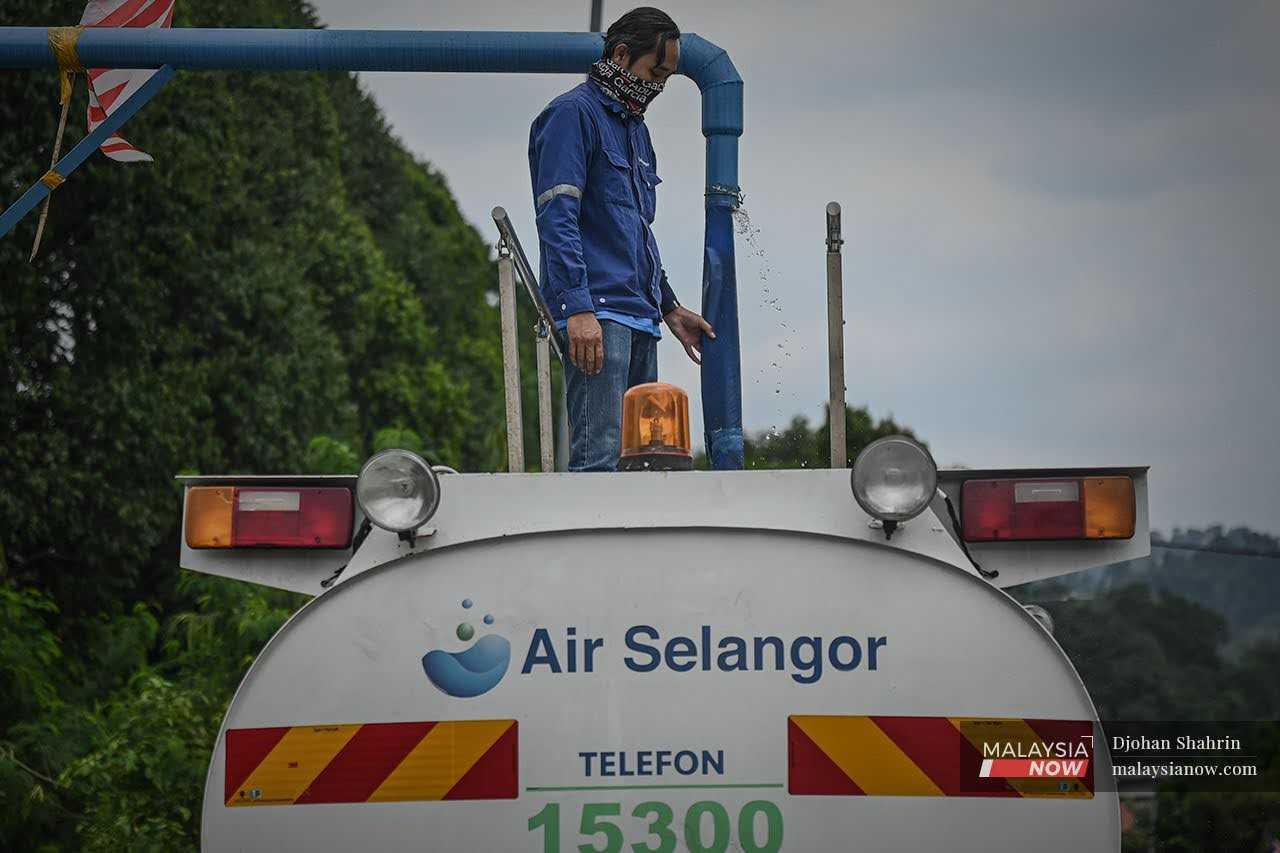 An Air Selangor worker fills a tanker with water in this file picture.