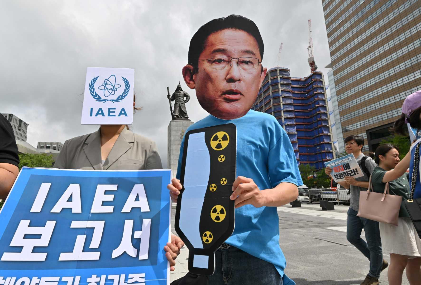 A South Korean activist wearing a mask of Japan's Prime Minister Fumio Kishida protests against the International Atomic Energy Agency's (IAEA) report on the Fukushima water release plan, at Gwanghwamun Square in Seoul on July 5. Photo: AFP