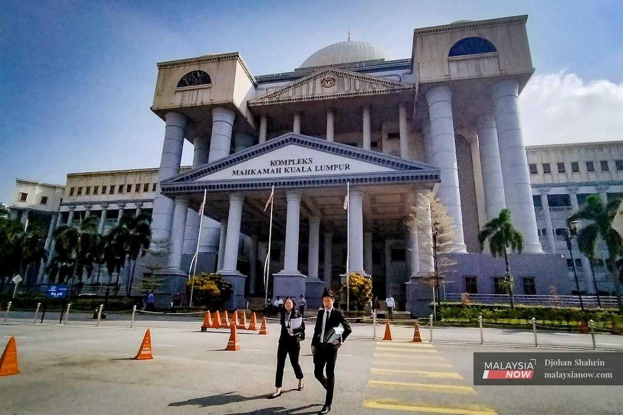 Lawyers walk outside the Kuala Lumpur court complex in Jalan Duta. 

