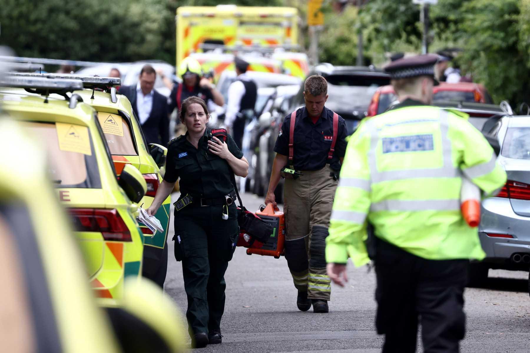 Paramedics and police officers walk near the private Study Prep girls' school following a car collision in Wimbledon, southwest London, on July 6. Photo: AFP