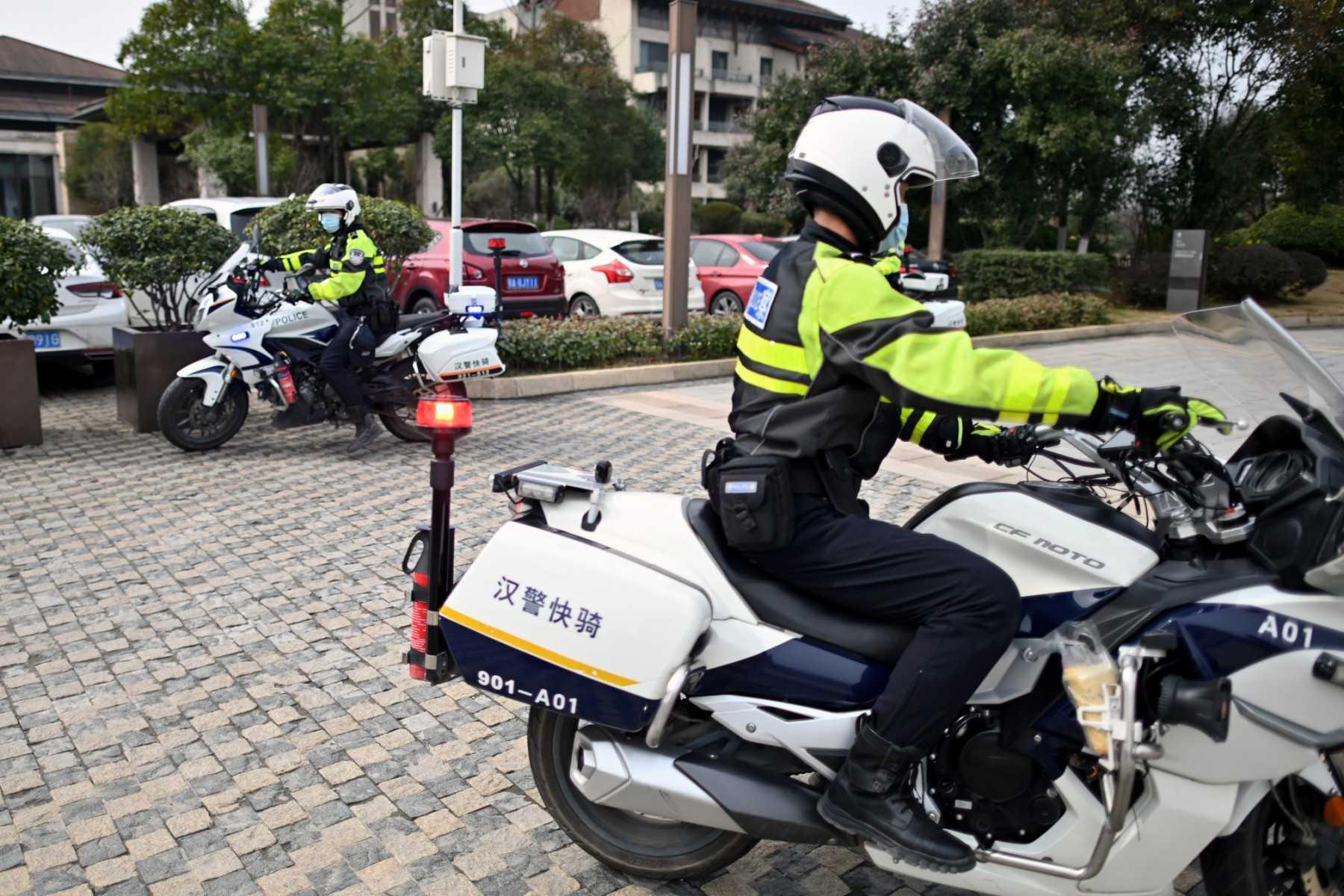 Chinese police on motorcycles are seen at the Wuhan Hilton Optics Valley Hote in Wuhan, China's central Hubei province on Feb 9, 2021. Photo: AFP