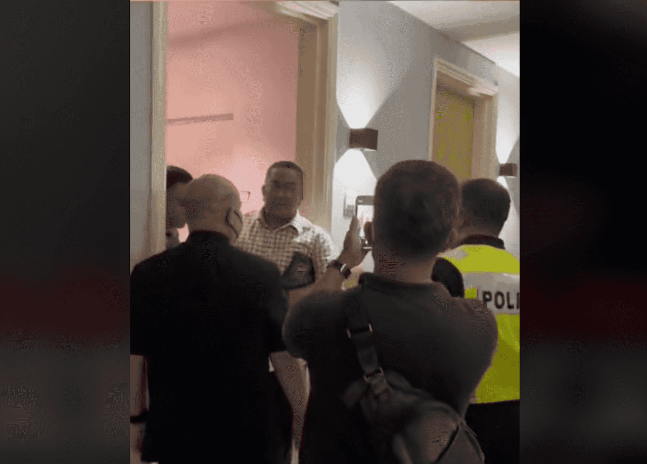 Kedah Menteri Besar Muhammad Sanusi Md Nor being arrested by a team of police officers early this morning, in a screenshot of a video making the rounds on social media.