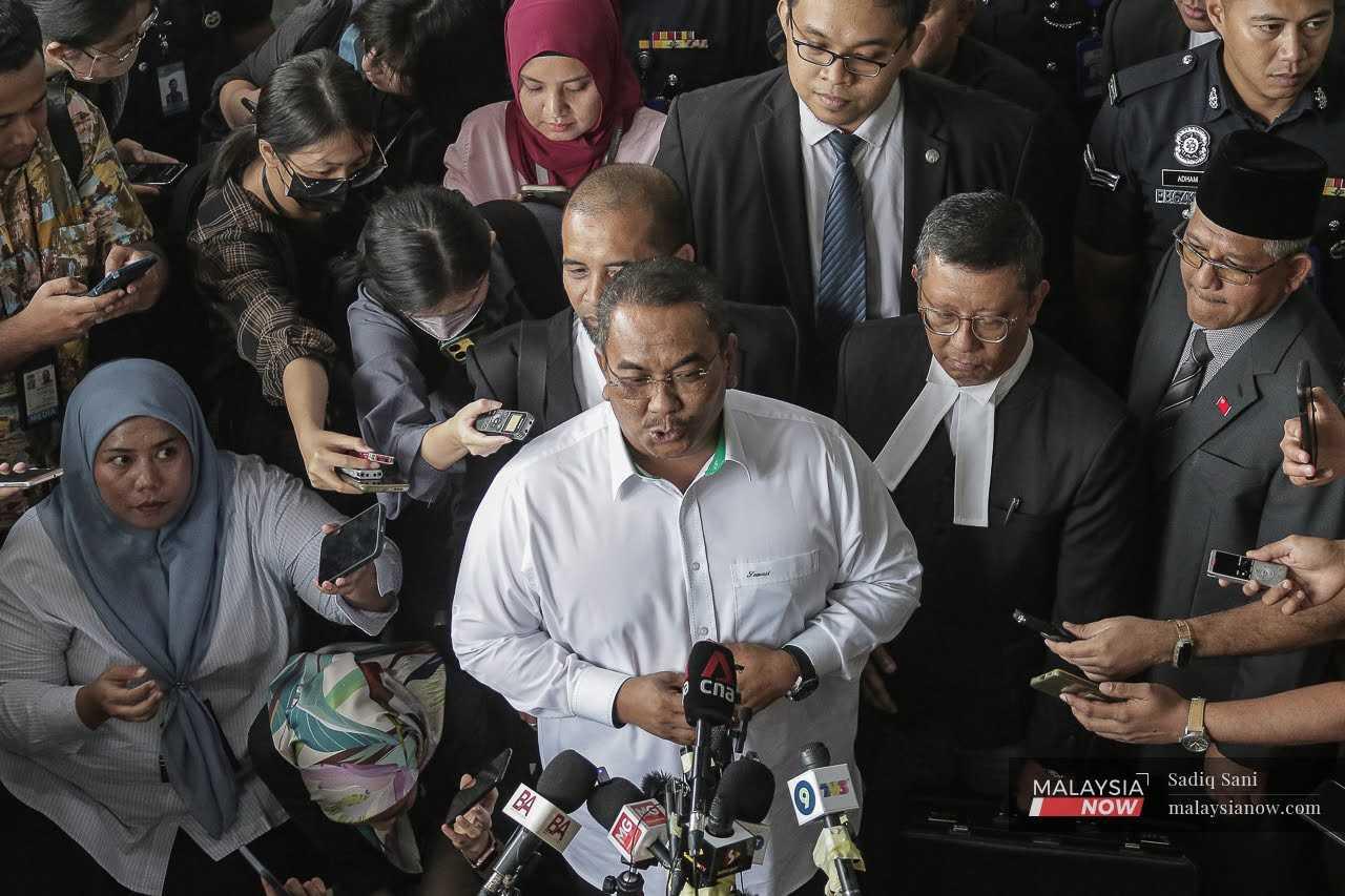 Kedah Menteri Besar Muhammad Sanusi Md Nor speaks to reporters at the Selayang Sessions Court after being charged with sedition, July 18. 
