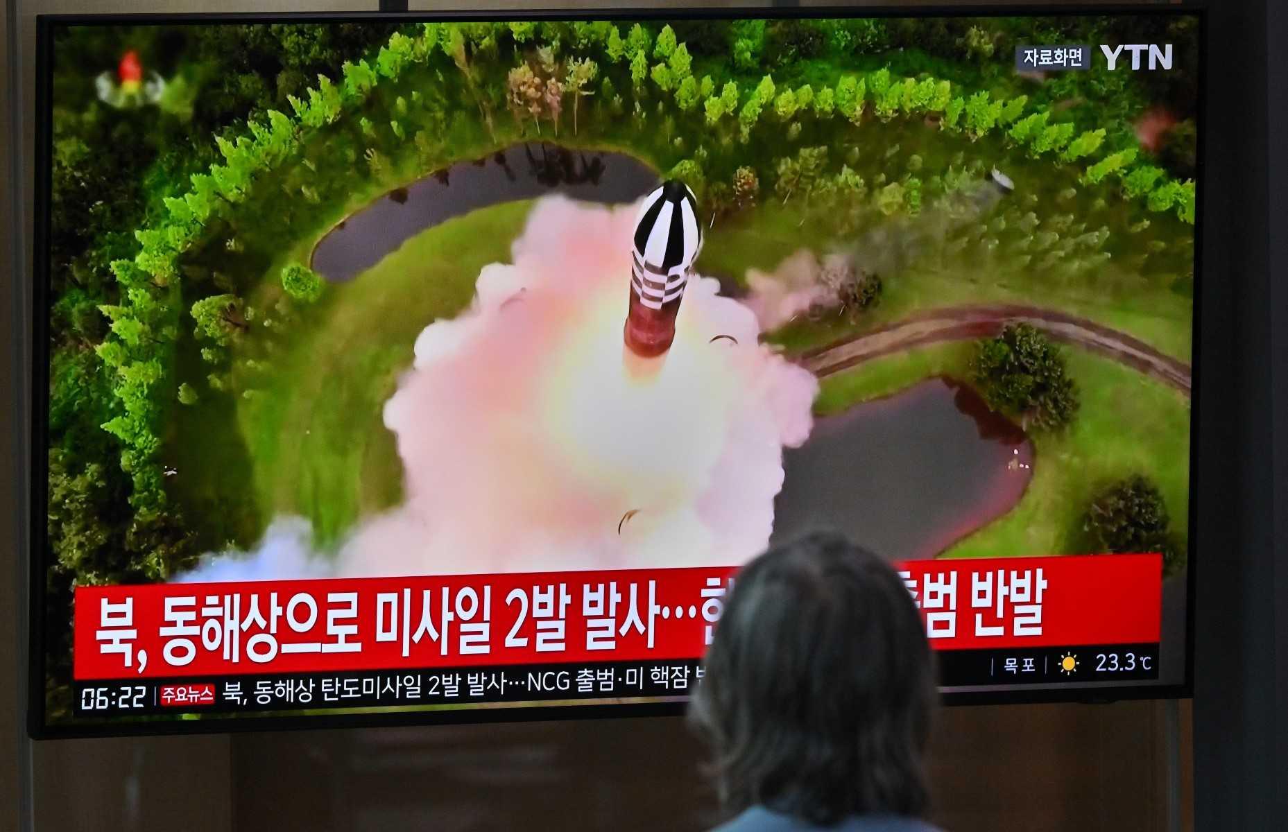 A man watches a television screen showing a news broadcast with file footage of a North Korean missile test, at a railway station in Seoul on July 19. Photo: AFP