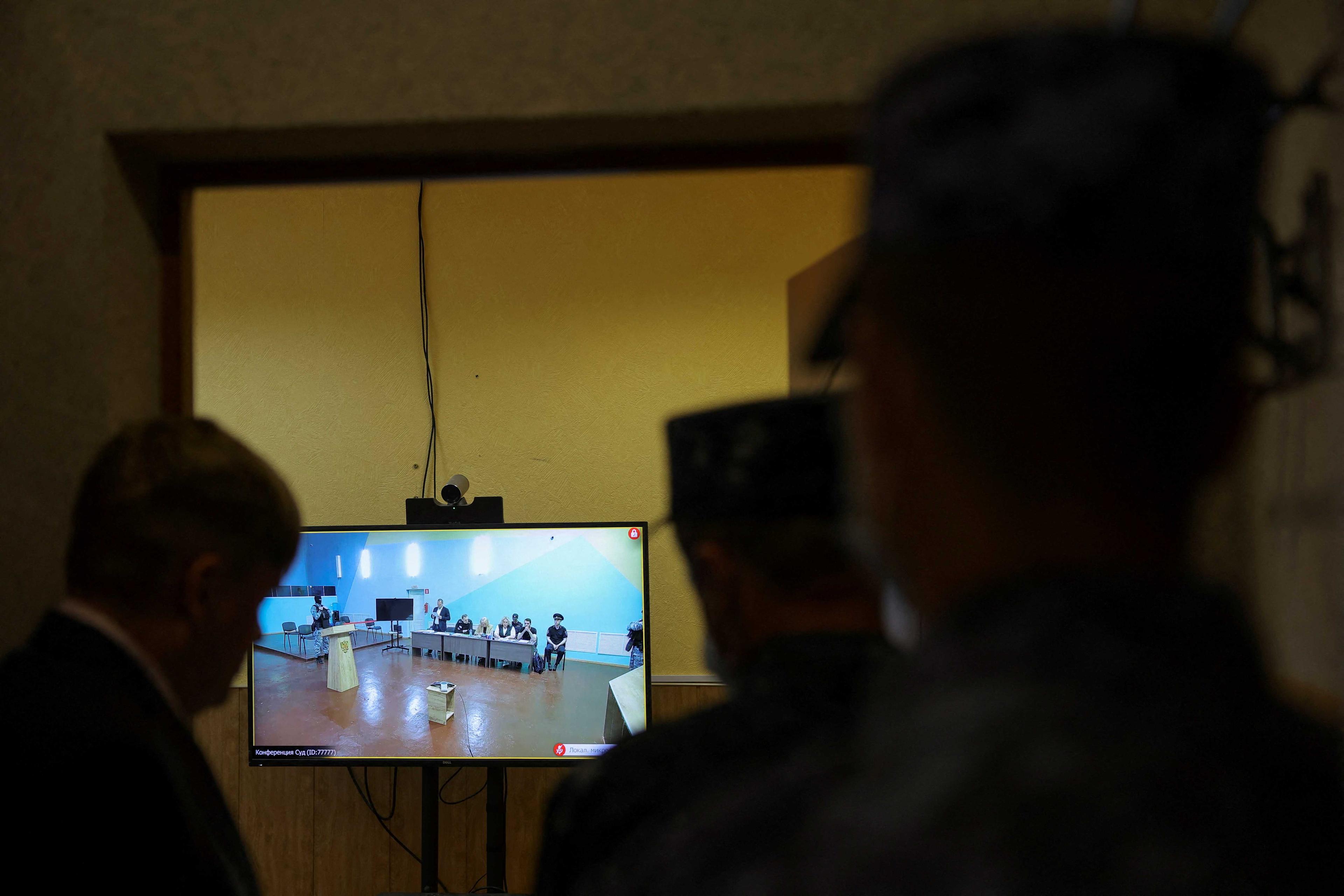 People look at a screen during a video link to an external hearing of the Moscow City Court in a new criminal case against Russian opposition politician Alexei Navalny on numerous charges, including the creation of an extremist organisation, at the IK-6 penal colony in the Vladimir region, Russia, June 19. Photo: Reuters