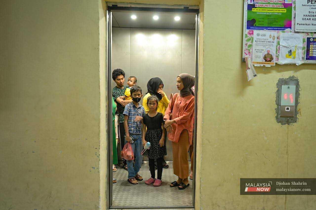 Residents enter a lift at a low-cost housing project in the capital city of Kuala Lumpur.