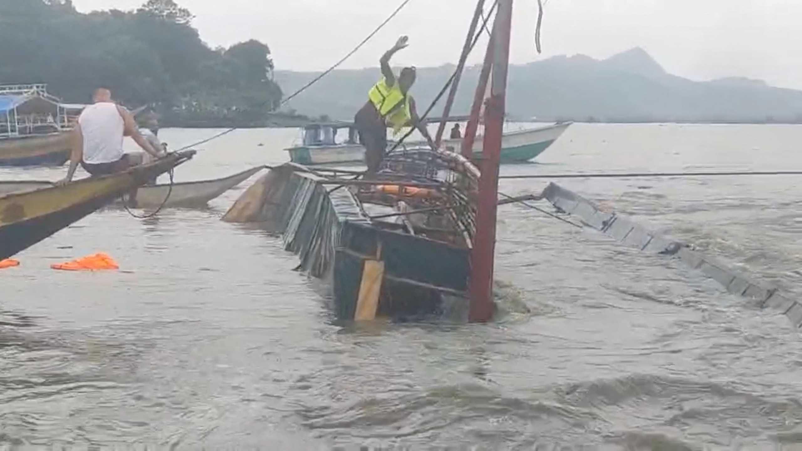 A man stands on the capsized passenger boat in Binangonan, Rizal province, Philippines, July 27, in this screen grab taken from a video by Philippine Coast Guard. Photo: Reuters