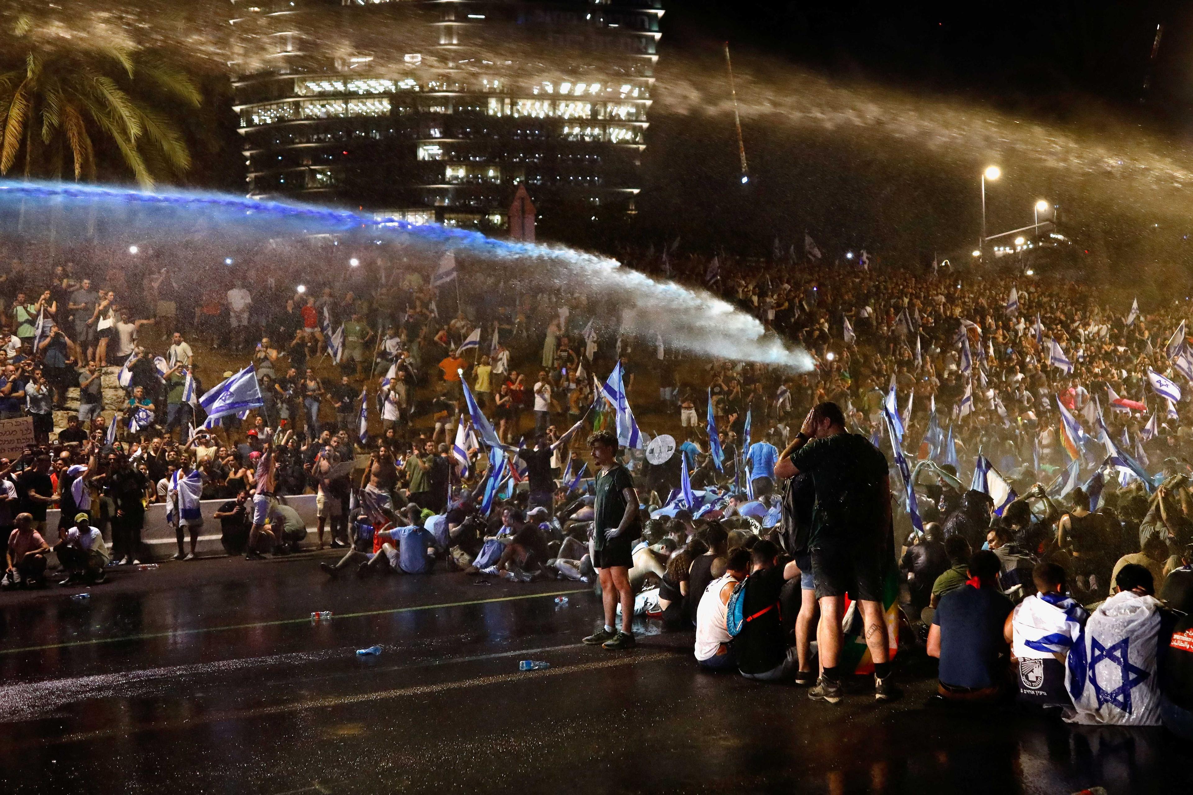 Police use water cannon as protesters block Ayalon Highway during a demonstration following a parliament vote on a contested bill that limits Supreme Court powers to void some government decisions, in Tel Aviv, Israel July 24. Photo: Reuters