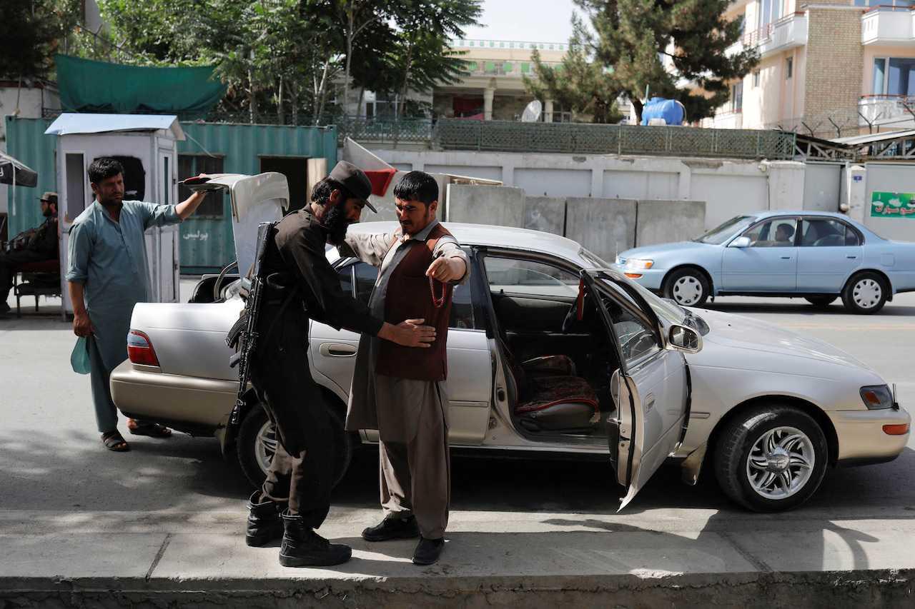 A Taliban soldier checks a man at a checkpoint in Kabul, Afghanistan, July 6. Photo: Reuters