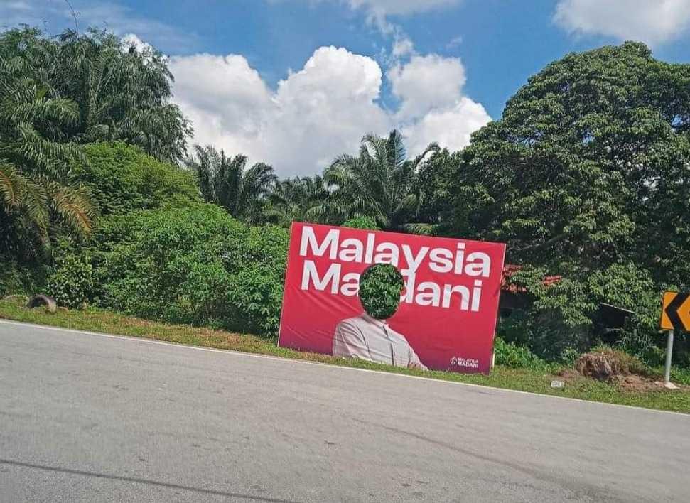 An instance of a banner bearing the image of Prime Minister Anwar Ibrahim being vandalised. Hundreds of such banners have sprung up nationwide since early last month.