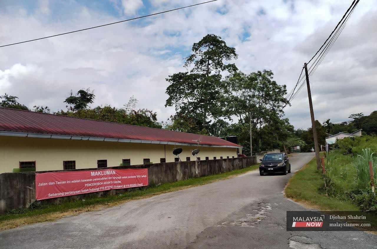 A banner hangs on a wall at Rawiyah Sulaiman Park, warning ECRL personnel against intruding into Batu 8 in Gombak.