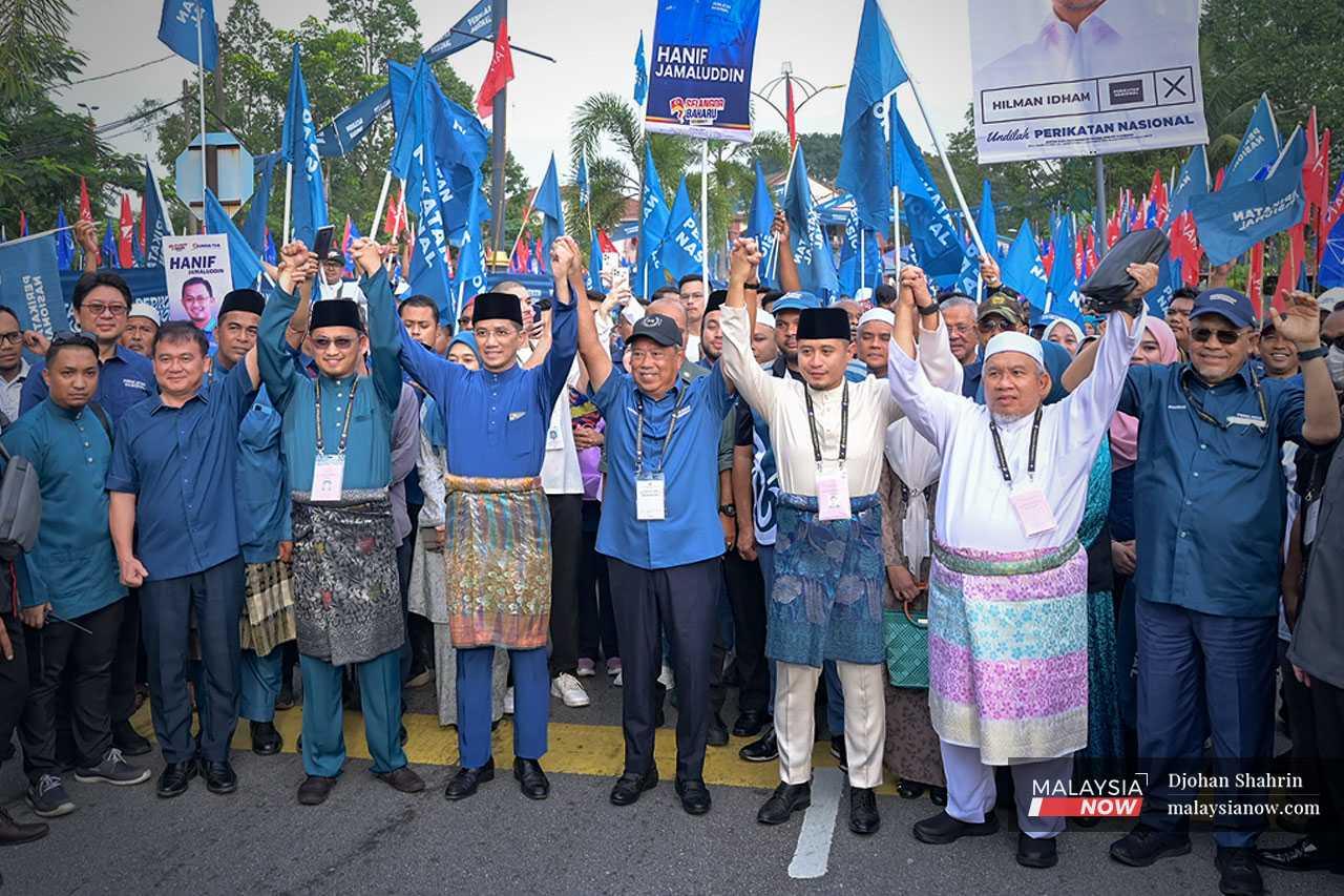 Perikatan Nasional chairman Muhyiddin Yassin poses with the coalition's candidates for Hulu Kelang, Gombak Setia and Sungai Tua on nomination day for the Aug 12 state election in Selangor. 