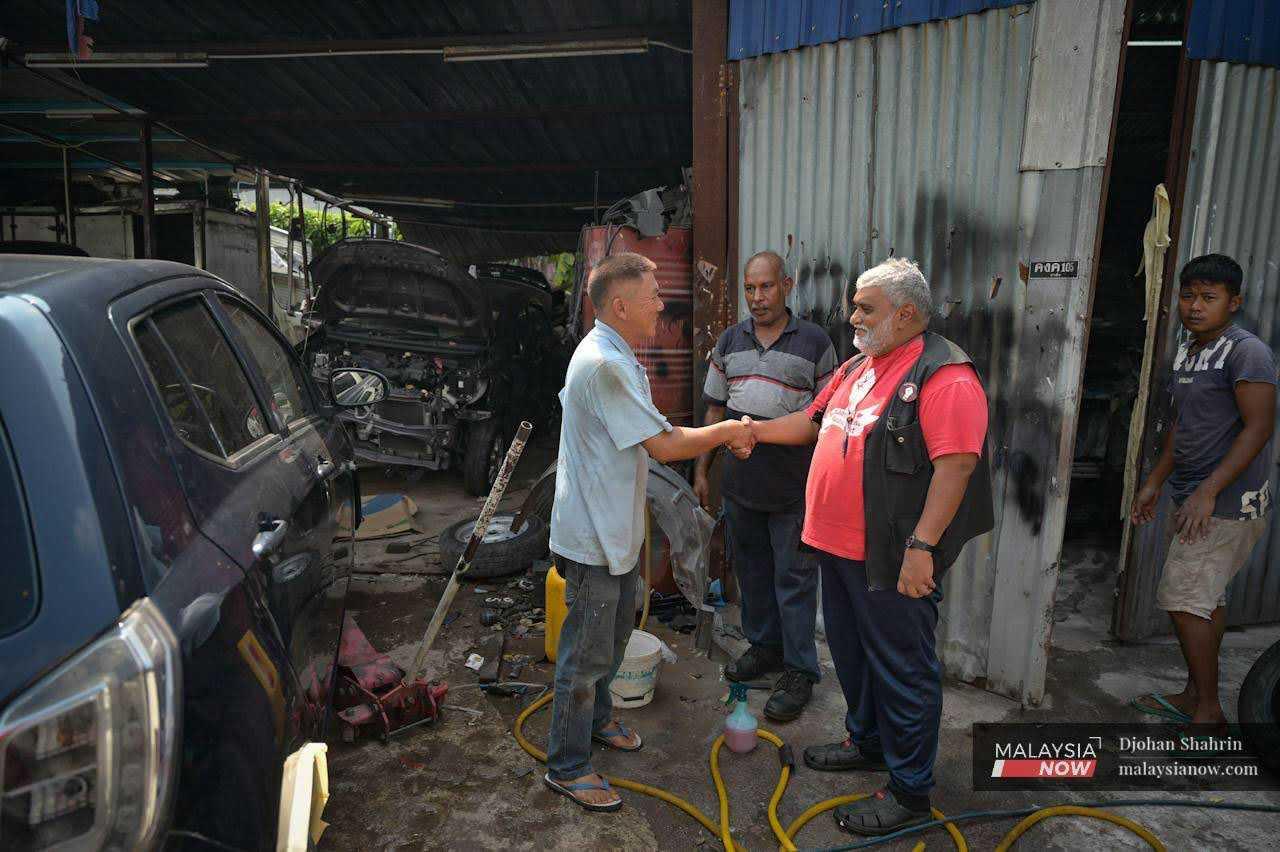 Arul meets with the owner of a car workshop. With only a few days of campaigning left, candidates are going all out, offering their aspirations to the community before the curtain falls on the campaign and people head to the polls on Aug 12.