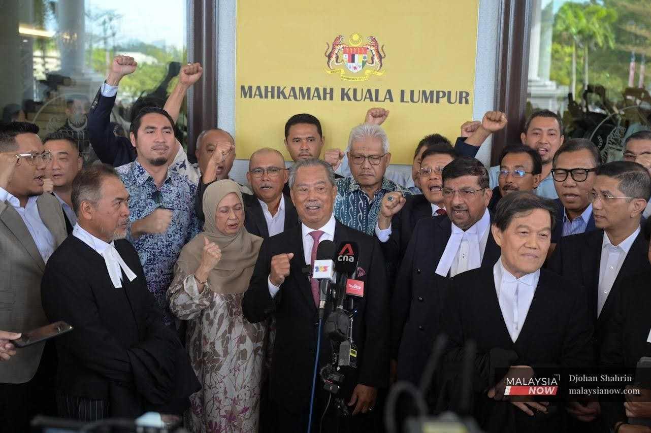 Former prime minister Muhyiddin Yassin (centre) speaks at a press conference today after being acquitted and discharged of four counts of abuse of power involving RM232.5 million, Aug 15.