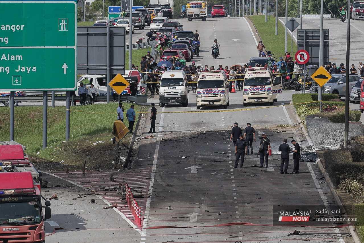 Police and paramedic teams at the scene of the plane crash in Elmina, Shah Alam.