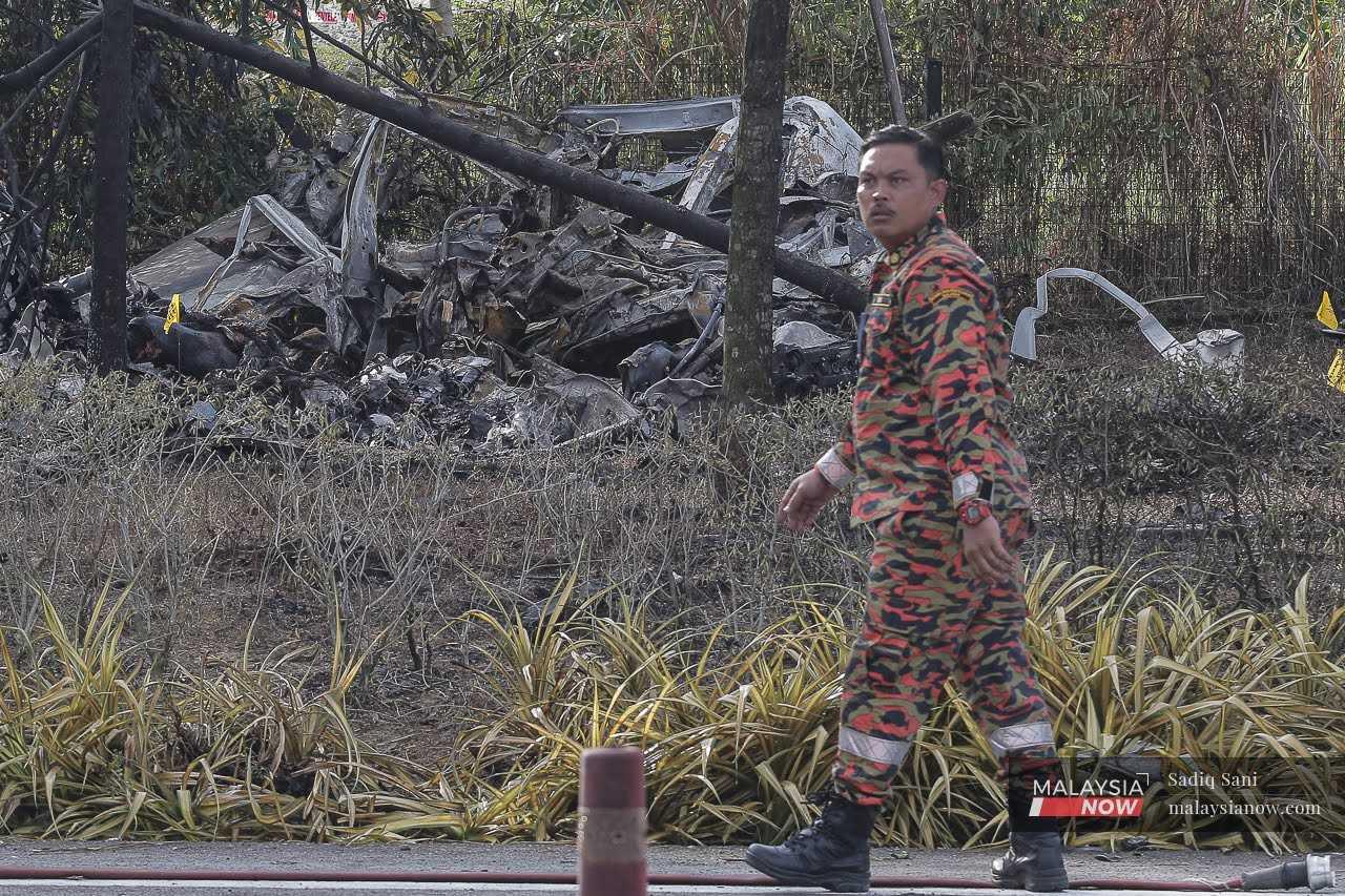 A firefighter walks through the site of the crash.