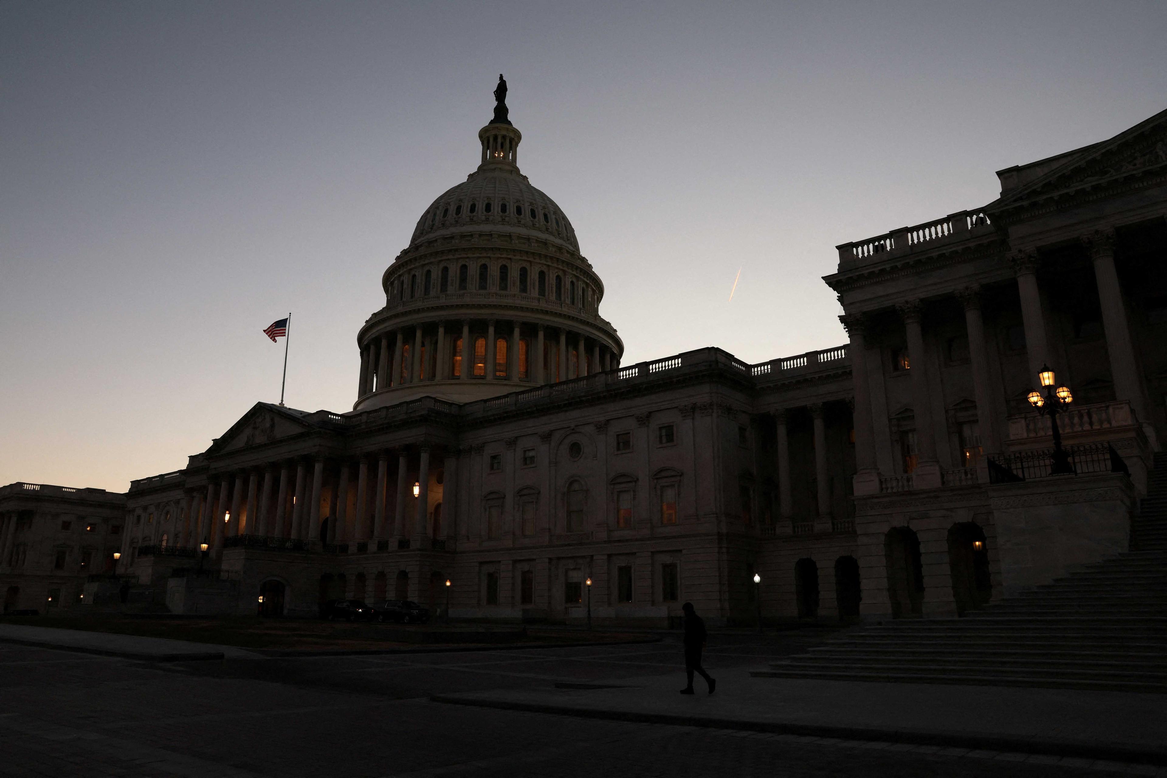 A person walks past the US Capitol building at sunset as the Republican-controlled House of Representatives reconvenes on Capitol Hill in Washington, US, Jan 9, Photo: Reuters