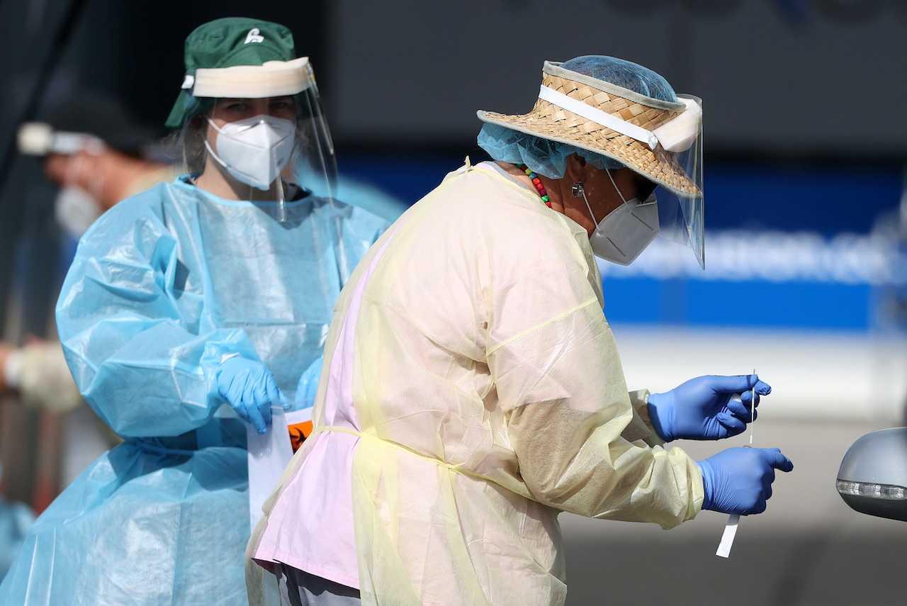 A medical worker administers a Covid-19 test at a testing clinic during a lockdown to curb the spread of an outbreak in this file picture taken in Auckland, New Zealand. Photo: Reuters