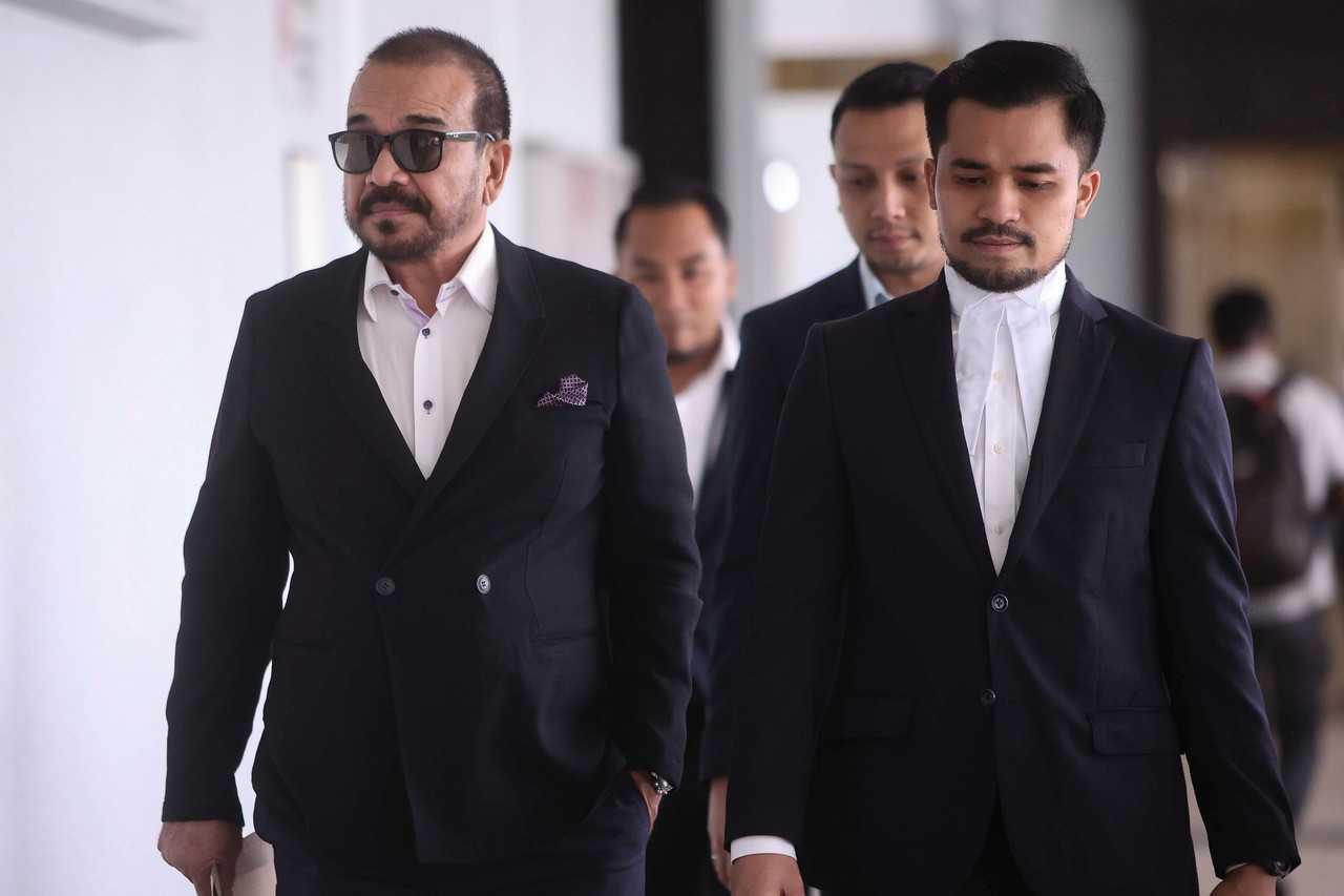 Businessman Khalid Mohamad Jiwa, better known as Datuk K (left), arrives at the Kuala Lumpur court complex ahead of the trial today, Aug 21. Photo: Bernama