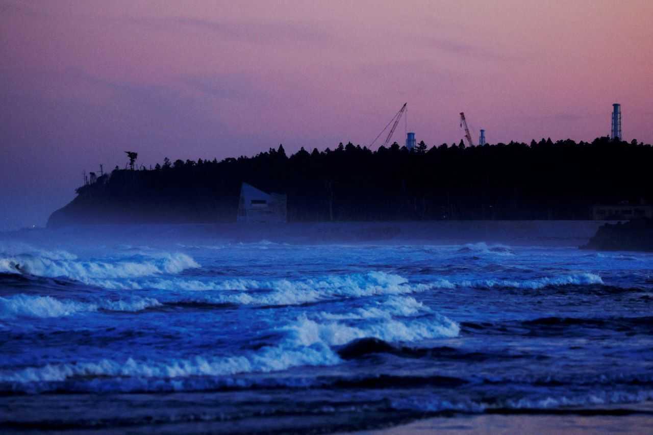 Ventilation stacks and cranes at the disabled Fukushima Dai-ichi nuclear power plant are seen from a beach in Namie, about 7km away from the power plant, in Fukushima Prefecture, Japan, Feb 28. Photo: Reuters