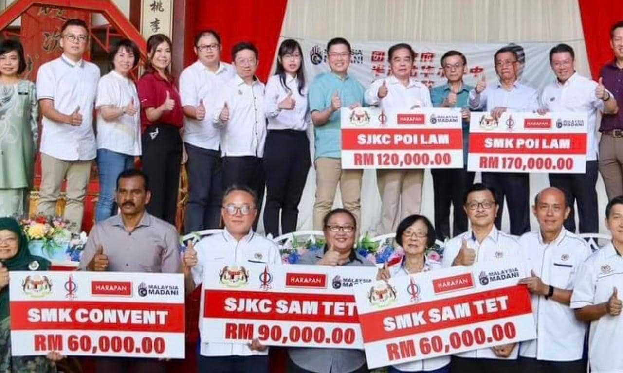 A picture of mock cheques bearing the Pakatan Harapan and DAP logos.