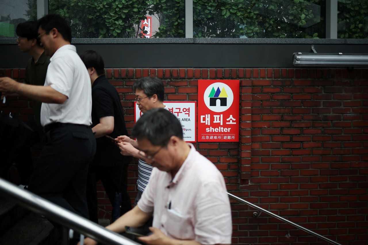 Pedestrians take shelter at a subway station as they take part in a nationwide civil defence drill, which is being conducted for the first time in six years, to prepare in case of an air raid, in central Seoul, South Korea, Aug 23. Photo: Reuters