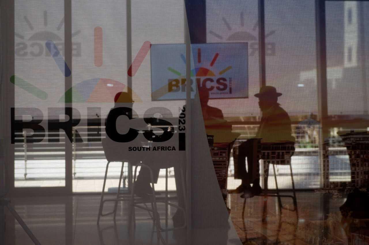South African delegates sit behind a glass with Brics logo as the Brics summit is held in Johannesburg, South Africa Aug 23. Photo: Reuters