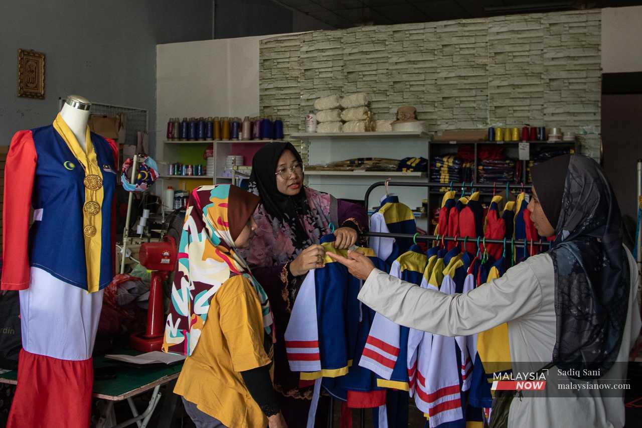 Amid the cutting and sewing, customers visit Helmaliza's shop to purchase her unique collections.