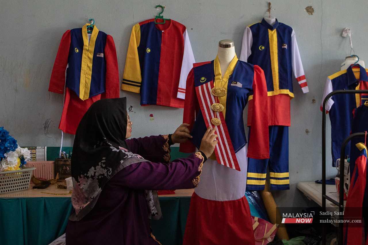 Helmaliza Md Isa examines her Jalur Gemilang-themed kebaya at her tailor shop in Klebang Restu, Ipoh, in preparation for Merdeka Day.