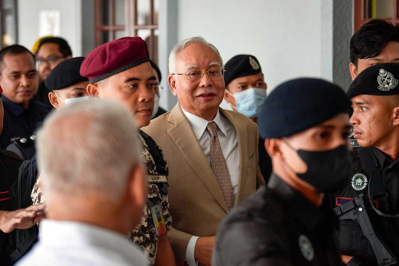 Former prime minister Najib Razak, escorted by security personnel at a court hearing in Kuala Lumpur. Photo: Bernama