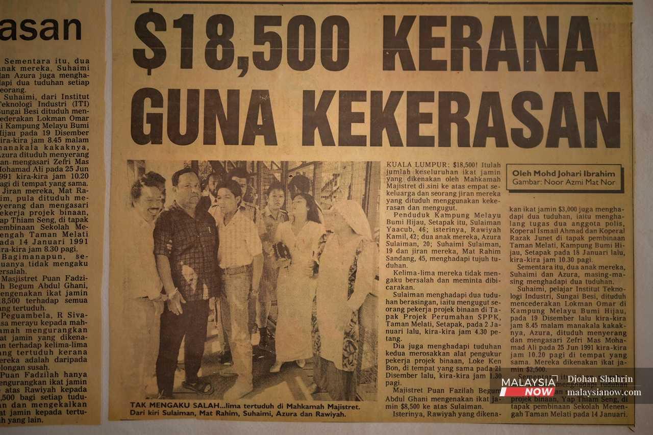 A newspaper excerpt from 1992 shows Rawiyah and her husband, accompanied by their children and a village resident, being charged in court for alleged violence and threats against construction workers in Kampung Melayu Bumi Hijau.