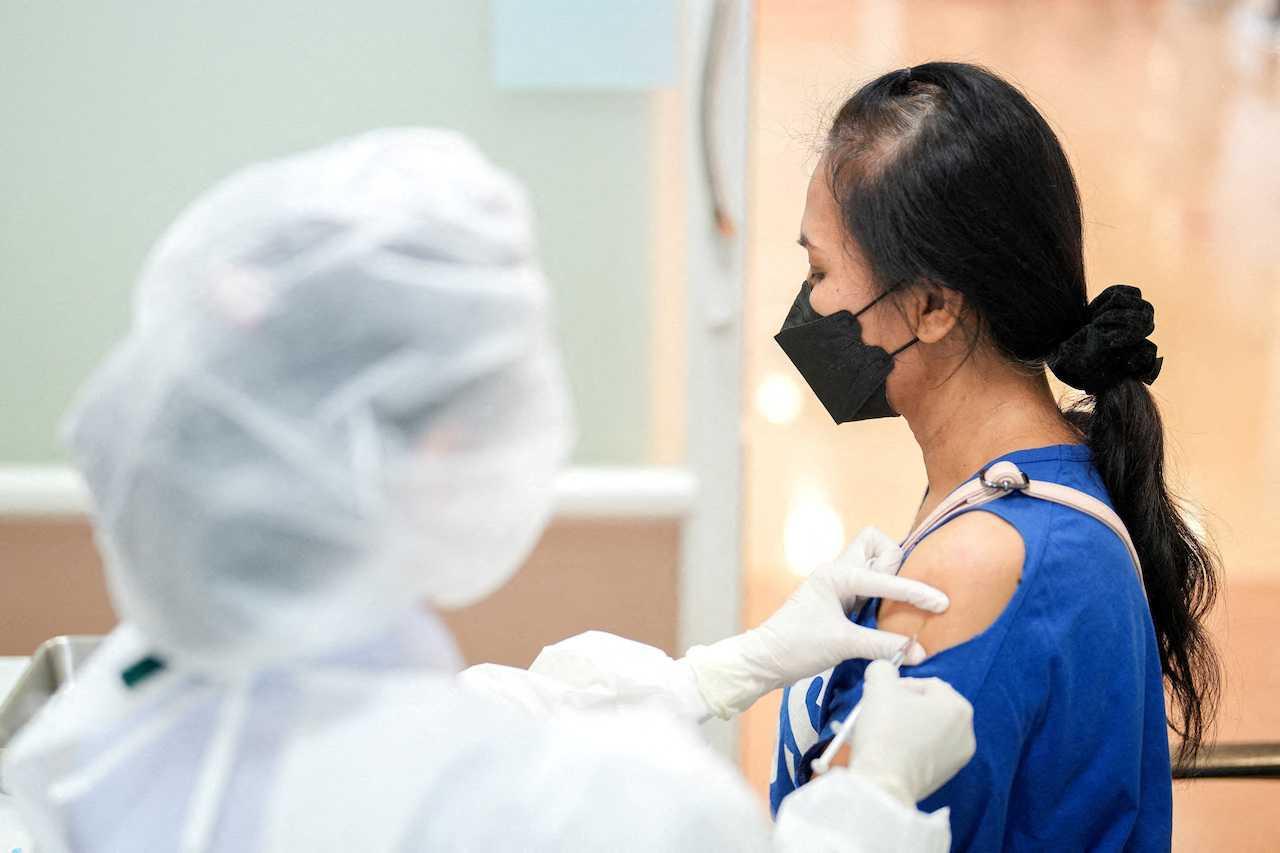 A woman receives a booster dose of the Pfizer-BioNTech vaccine against Covid-19 at a hospital in Bangkok, Thailand, Jan 5. Photo: Reuters