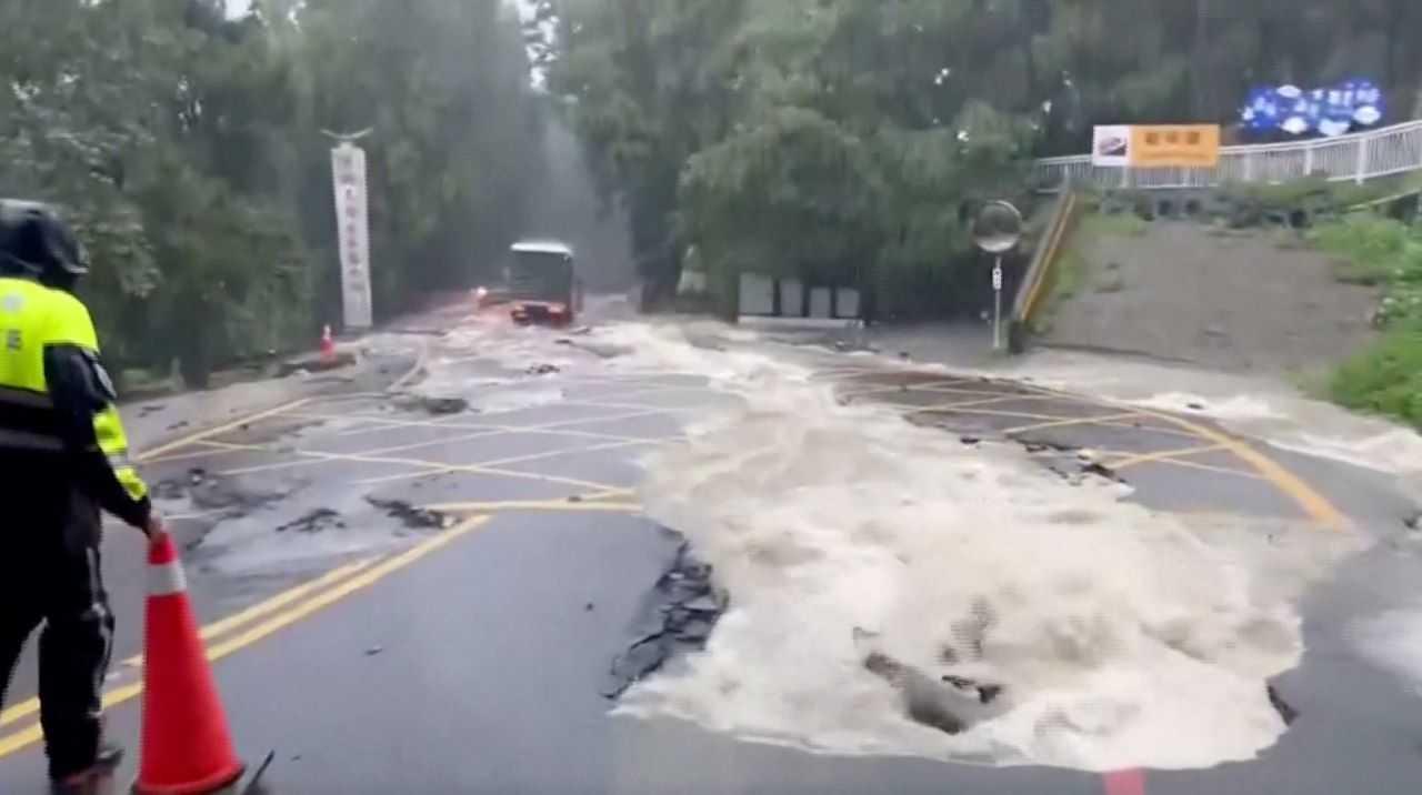A person stands on a flooded street following heavy rains due to Typhoon Khanun, in Nantou county, Taiwan Aug 5, in this screen grab taken from a video provided by CTI. Photo: Reuters