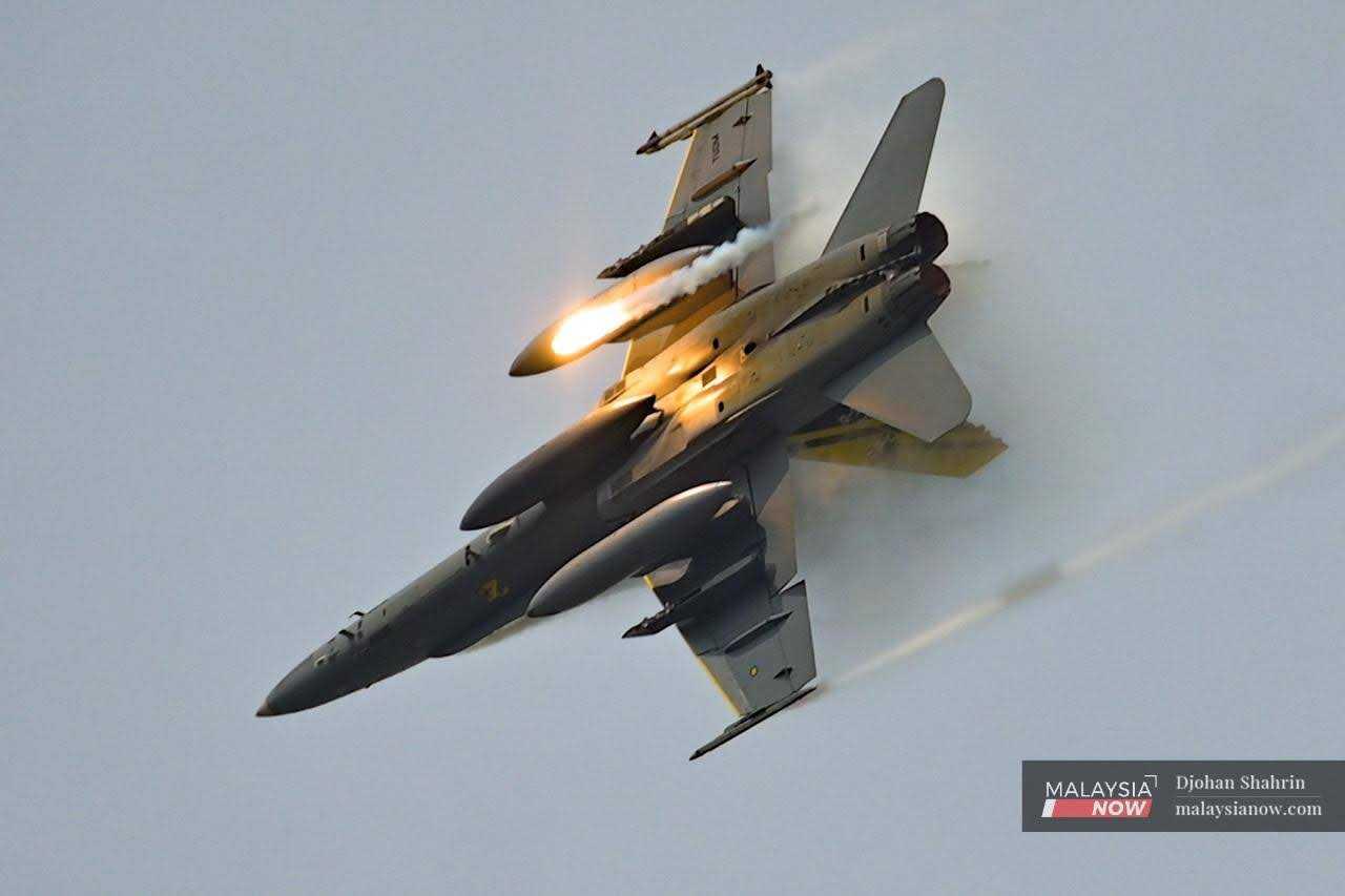 A F/A-18 Hornet fighter jet performs during the acrobatic airshow.
