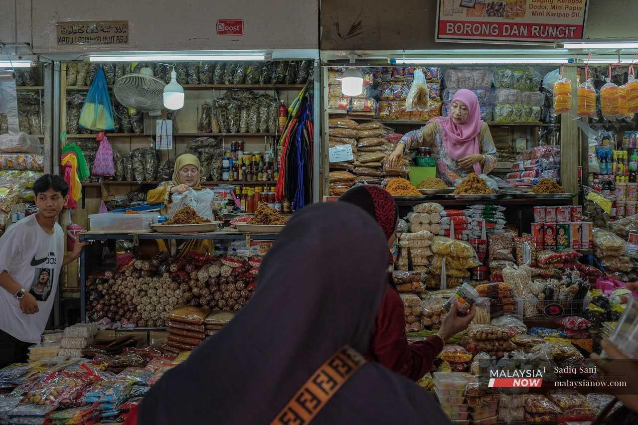 Traders work at their shops in the landmark Siti Khadijah market in Kota Bharu, Kelantan.

