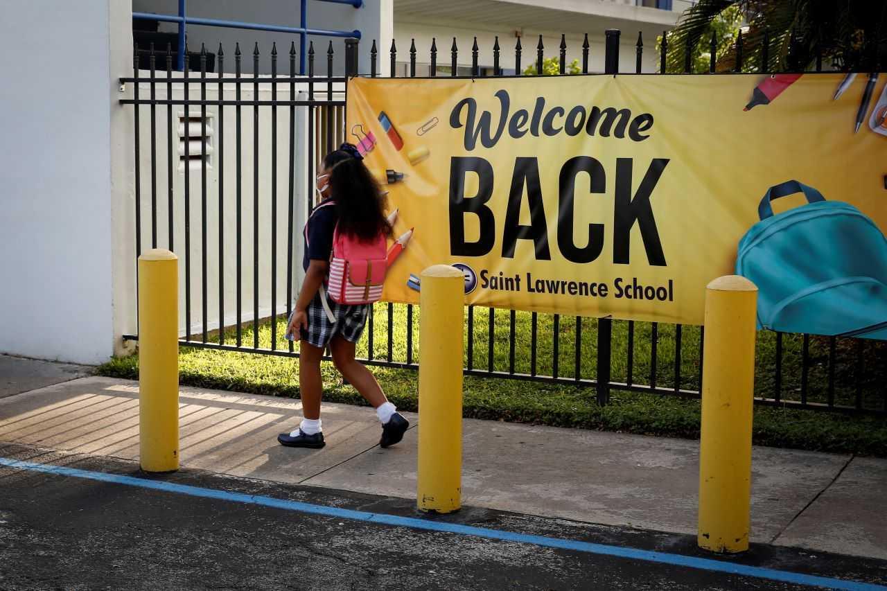 A student wearing a protective masks, walks past a 'Welcome back' banner on the first day of school at St Lawrence Catholic School in North Miami Beach, Florida, US Aug 18, 2021. Photo: Reuters