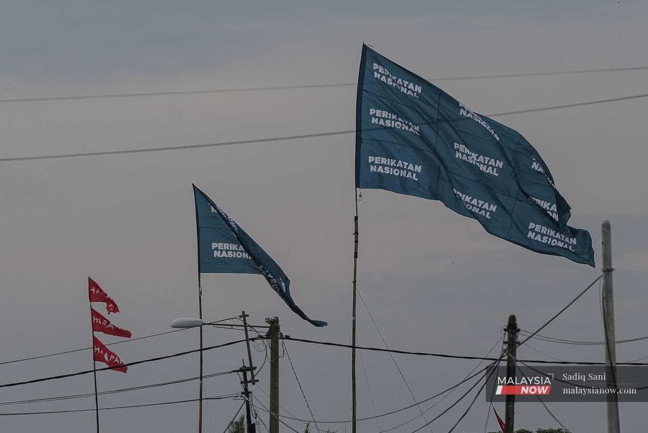 The flags of Pakatan Harapan and Perikatan Nasional flutter in the breeze ahead of the by-election in Sempang Jeram, Johor, on Sept 9.