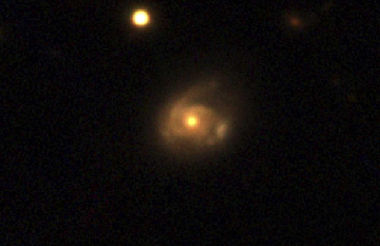 The interaction between a supermassive black hole in a galaxy named 2MASX J02301709+2836050 and a star orbiting it is seen in this image captured by the Pan-STARRS telescope, in Hawaii, in an undated handout image provided by Nasa. Photo: Reuters