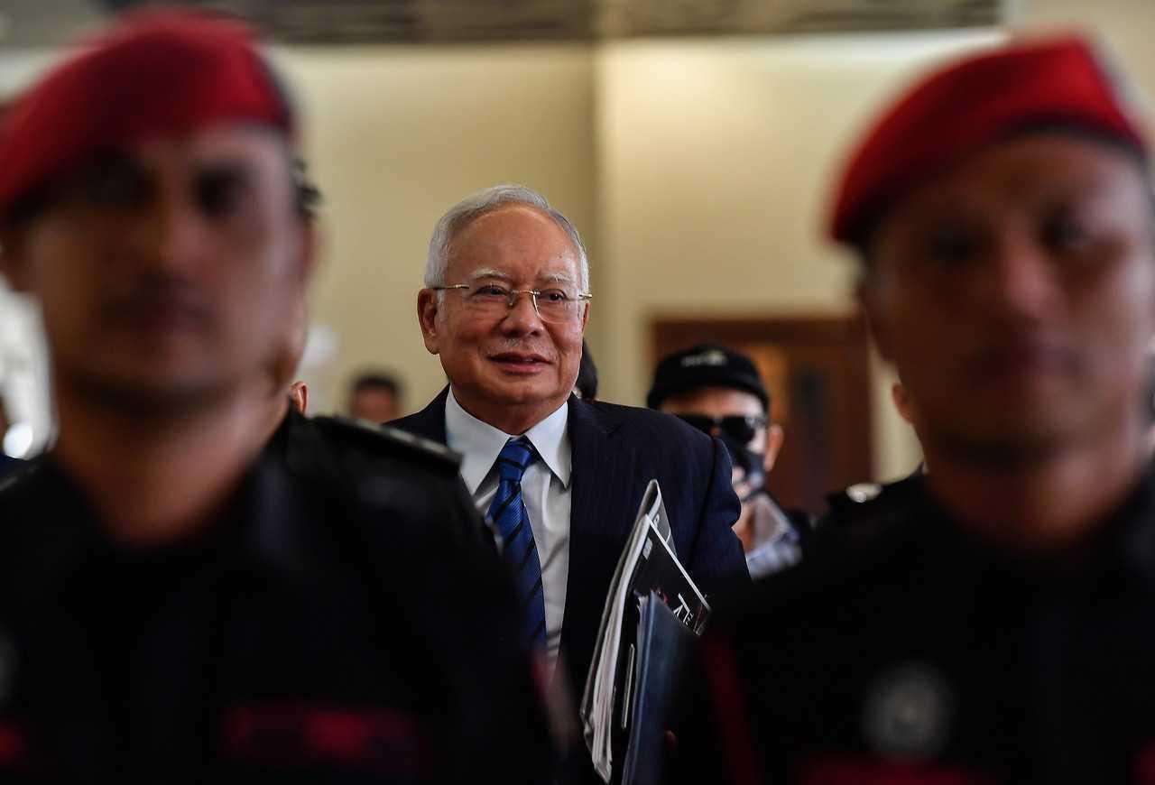 Bekas perdana menteri Najib Razak, diiringi anggota keselamatan pada perbicaraan mahkamah di Kuala Lumpur. Gambar: Bernama