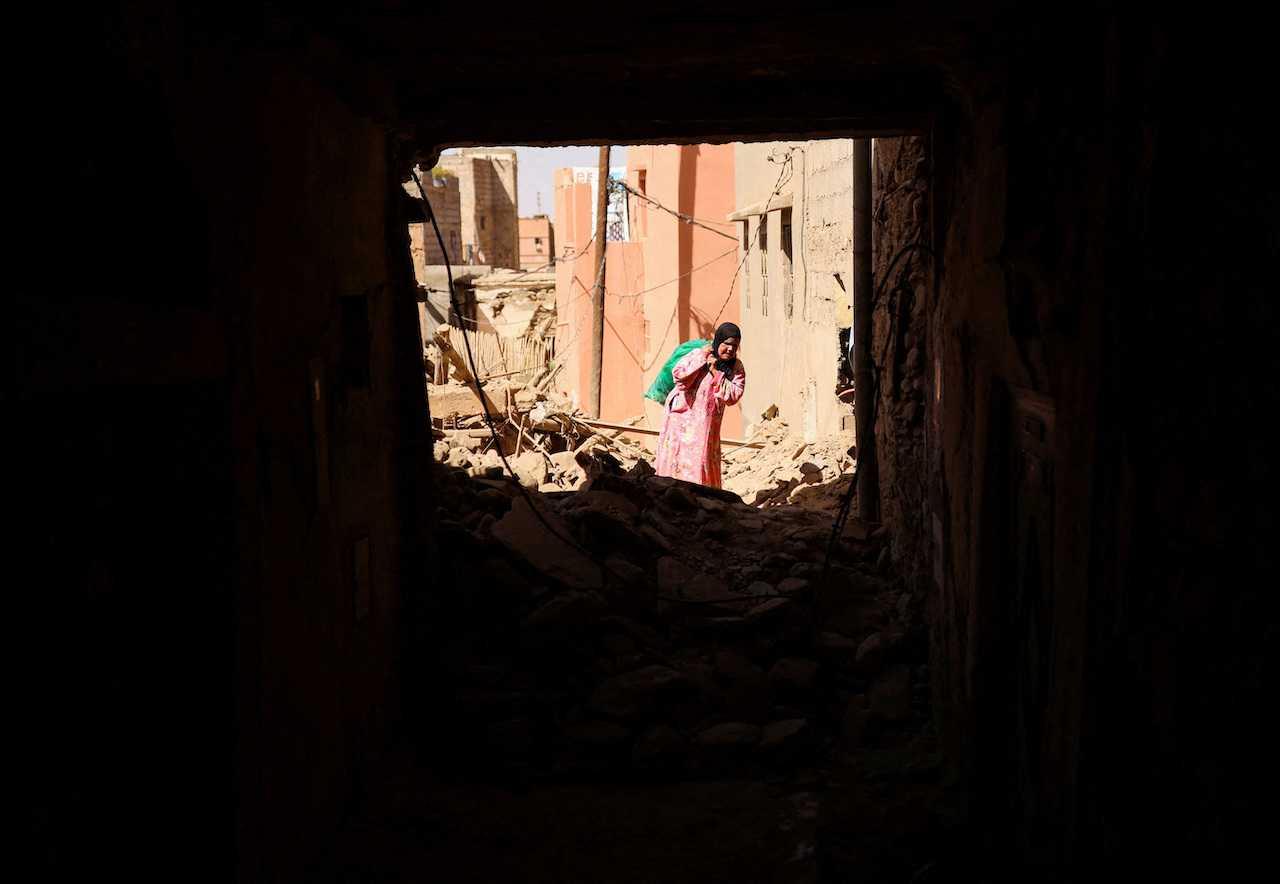 A woman carries her belongings in the aftermath of a deadly earthquake in Amizmiz, Morocco, Sept 10. Photo: Reuters