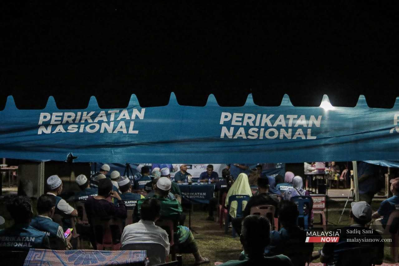 Attendees listen to a ceramah by Perikatan Nasional ahead of the by-election in Simpang Jeram, Johor, Sept 5. 
